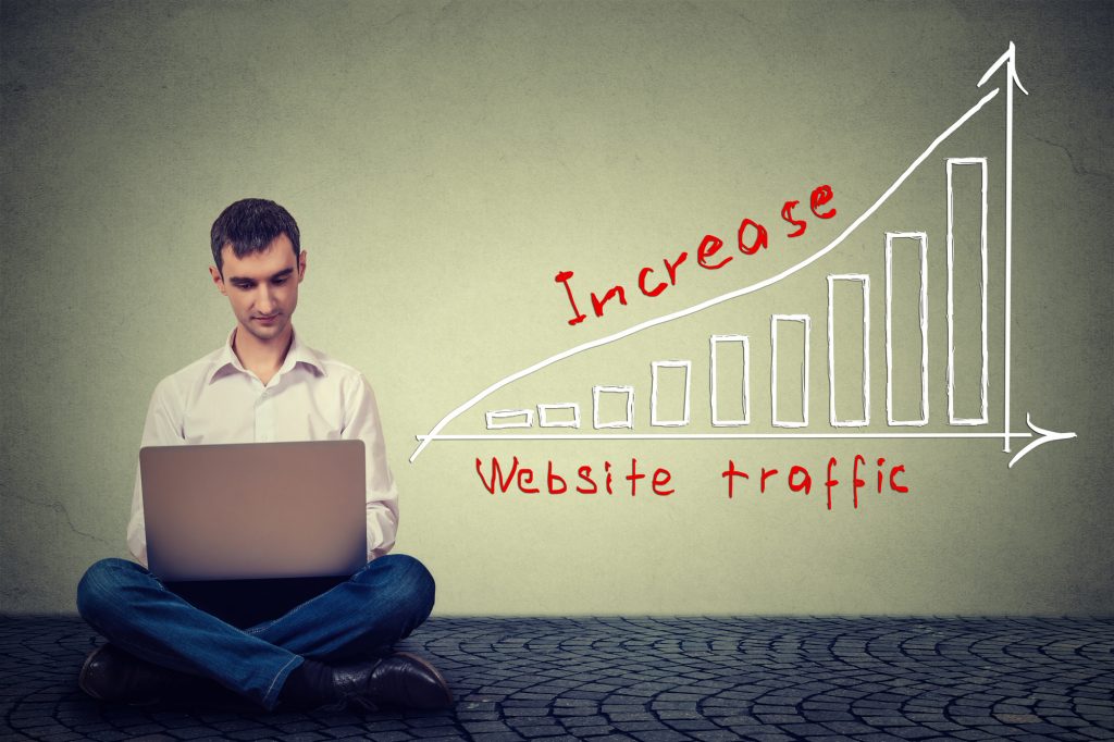 Man increasing website traffic with graph